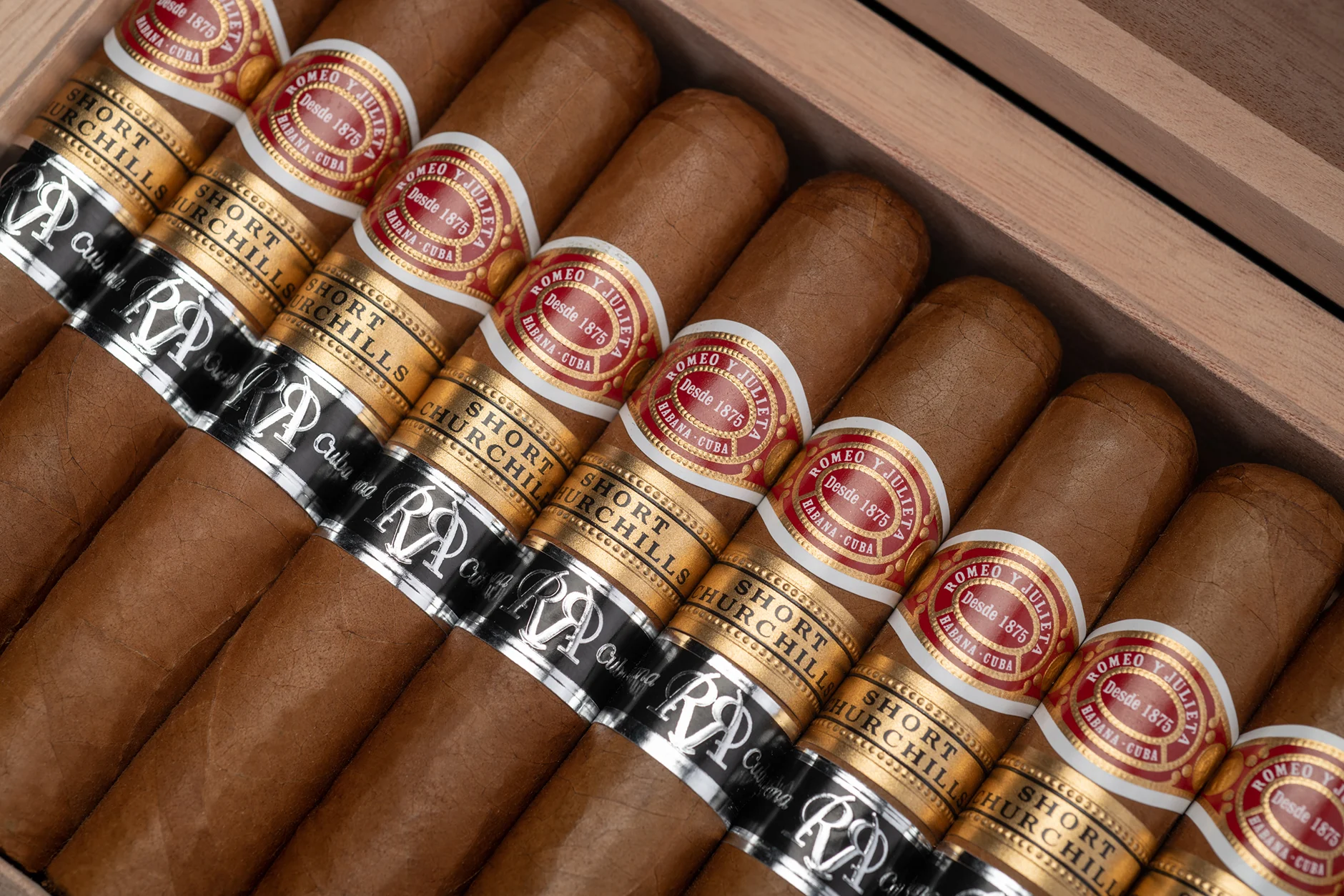 A box of Romeo y Julieta Short Churchills Reserva, cigars stacked and double banded